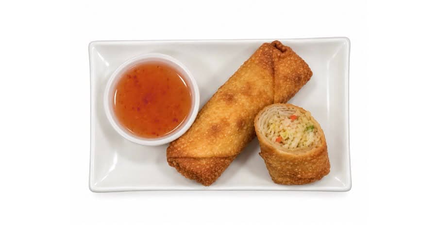 Crispy egg roll cut in half on a plate